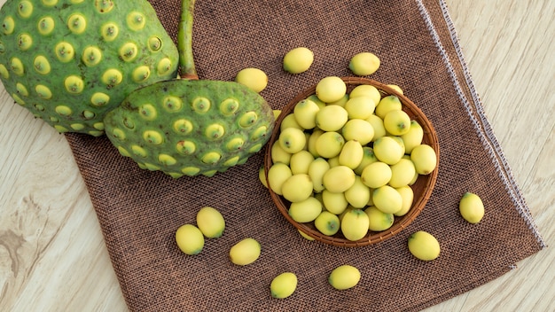 Green lotus seeds on a wooden table. Premium Photo