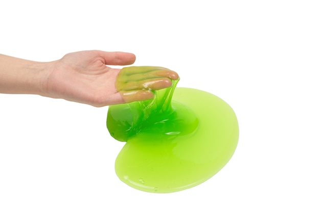 Premium Photo | Green slime toy in woman hand isolated on white background.