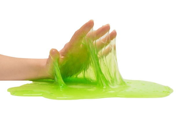 Premium Photo | Green slime toy in woman hand isolated on white