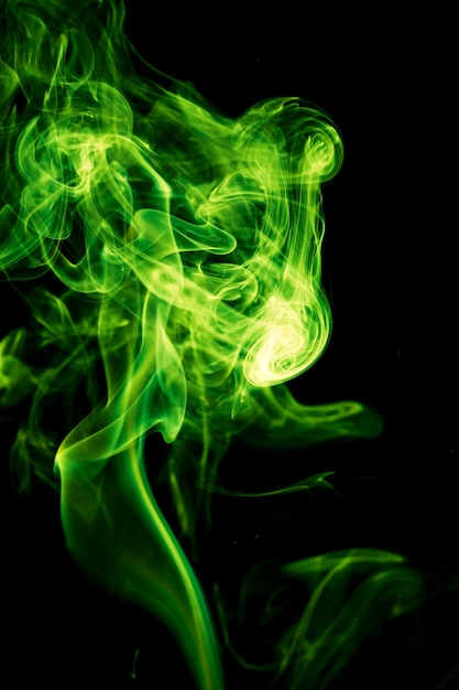 Premium Photo | Green smoke on black background.