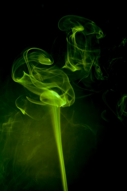 Premium Photo | Green smoke on black background.