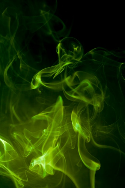 Premium Photo | Green smoke on black background.