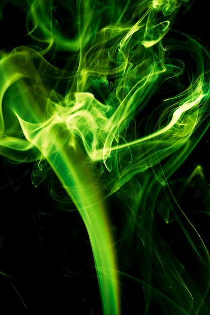 Premium Photo | Green smoke on black background.