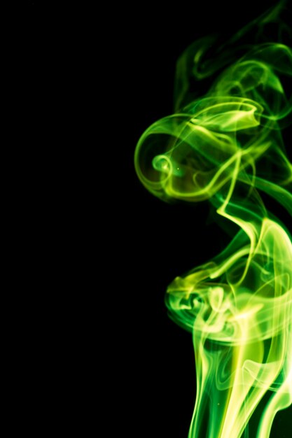 Premium Photo | Green smoke on black background.