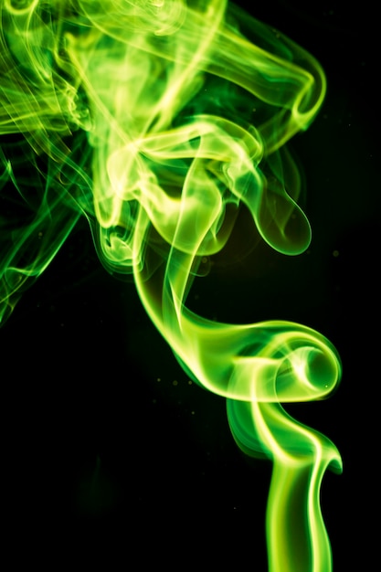 Premium Photo | Green smoke on black background.