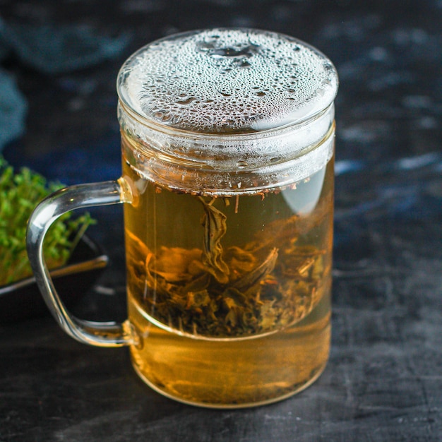 Premium Photo | Green tea large leaf freshly brewed drink