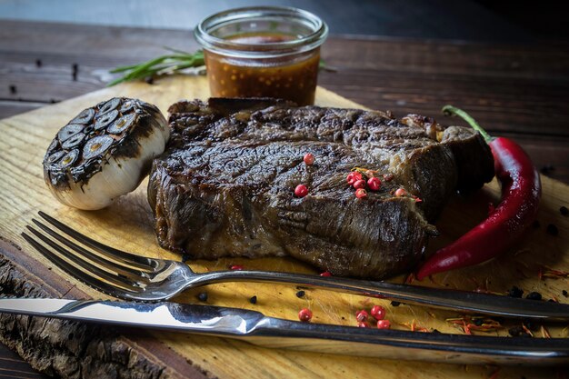 Premium Photo Grilled Beef Steak With Bourbon Sauce On Wooden Cutting Board
