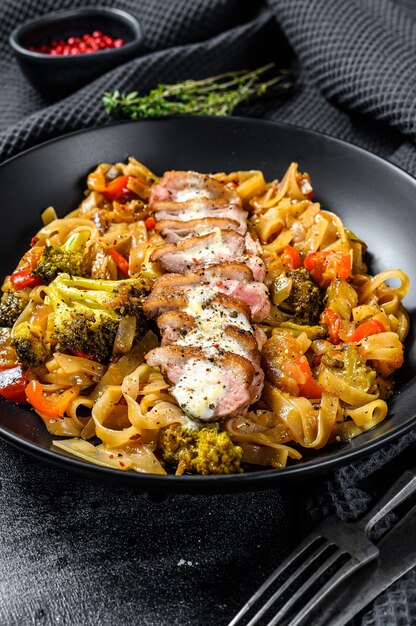 Premium Photo | Grilled duck breast with udon noodles and vegetables