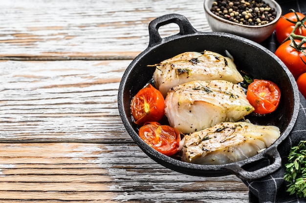 Premium Photo | Grilled pollock or coalfish fillets in a pan