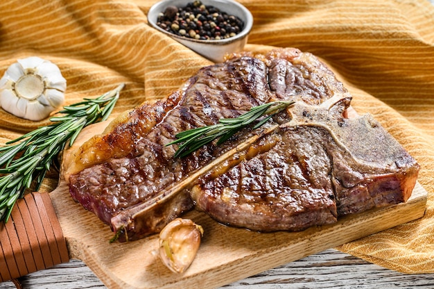 Premium Photo | Grilled t-bone steak on a cutting board