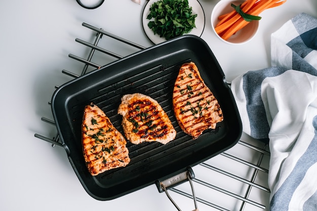 Premium Photo Grilled Turkey Steak With Herbs And Spices In Black Grill Pan On The Table