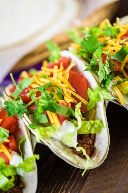 Premium Photo | Ground beef tacos with romaine lettuce, diced tomatoes ...