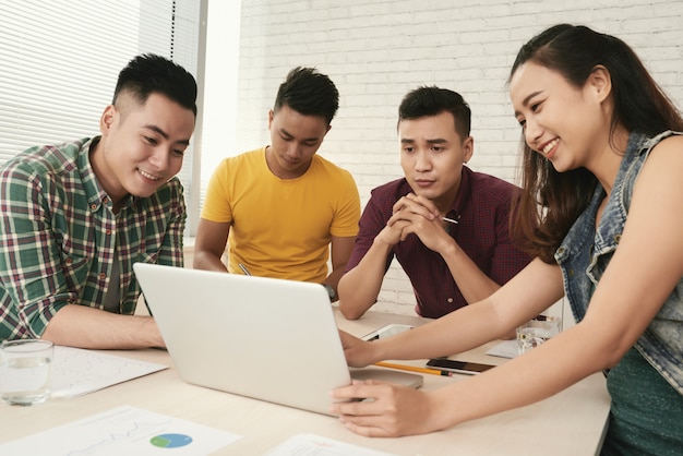 group casually dressed young asian people standing around table looking laptop screen 1098 18618 - 6 Alasan Mengapa Harus Kuliah di Universiti Utara Malaysia (UUM)