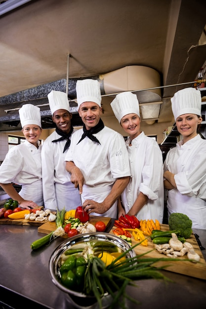 Premium Photo | Group of chefs preparing food in kitchen