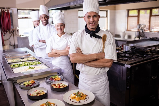 Premium Photo | Group Of Chefs Standing With Arms Crossed In Kitchen