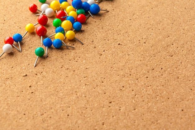 Premium Photo | Group of colorful push pins on cork bulletin board