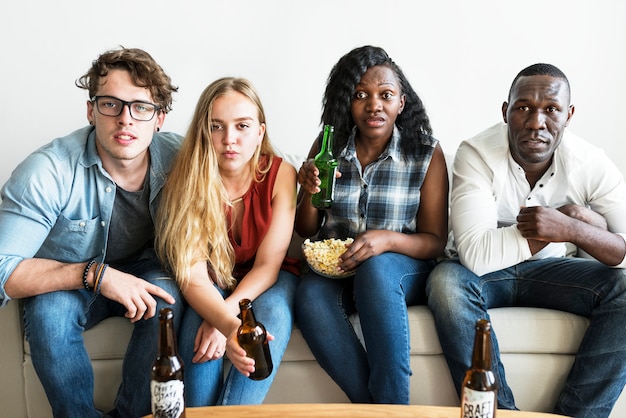 Group of diverse friends watching sports together seriously Premium Photo