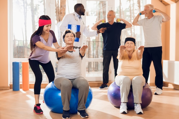 Premium Photo | Group of elderly people doing gymnastics in a nursing home.