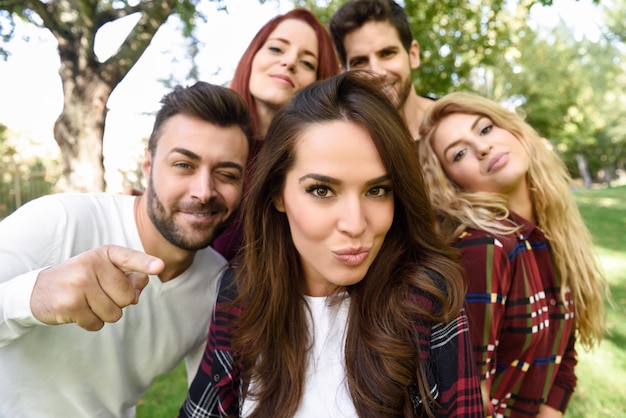 Free Photo | Group of friends in a selfie with a girl in the middle putting kiss face