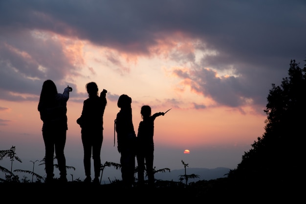 Group of happy people playing at summer sunset in nature | Free Photo