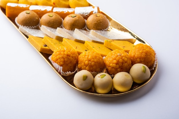 Premium Photo | Group of indian assorted sweets or mithai with diya