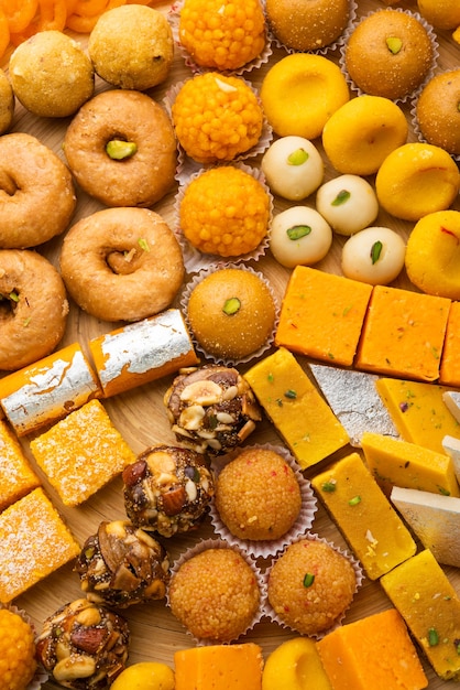 Premium Photo Group Of Indian Assorted Sweets Or Mithai With Diya