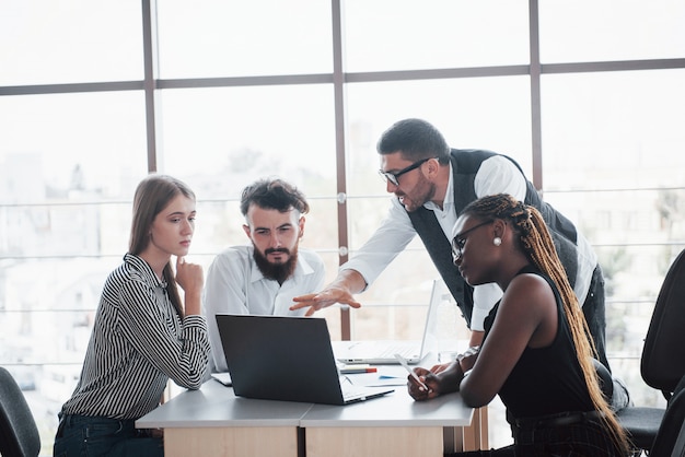 A group of multinational busy people working in the office Free Photo