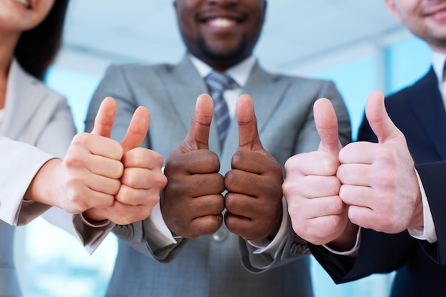 group-of-happy-workmates-showing-thumbs-up-photo-free-download