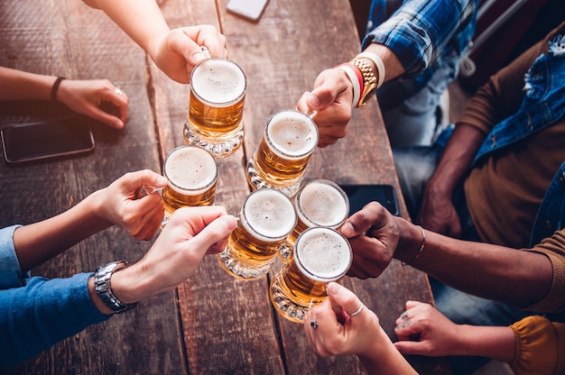 Premium Photo | Group of people enjoying and toasting a beer in brewery ...