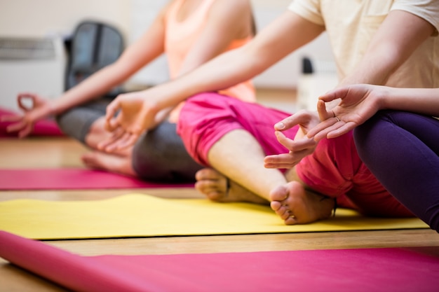 Group of people sitting in lotus position