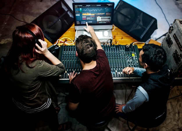 Group of people at a sound mixer station Free Photo