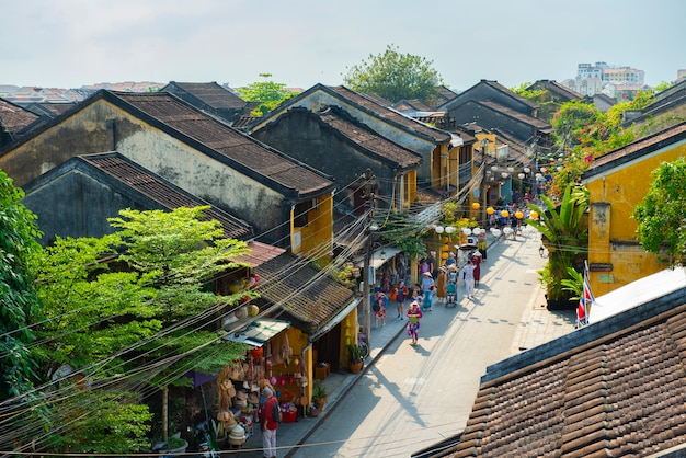 Group of people travel hoian old town visit local shop. Premium Photo