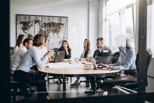 Group of people working out business plan in an office Free Photo