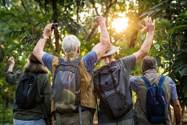 Premium Photo | Group of senior adults trekking in the forest