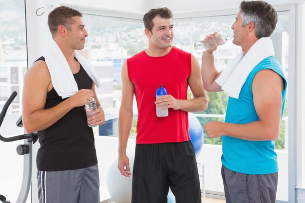 Premium Photo | Group of smiling men talking each other