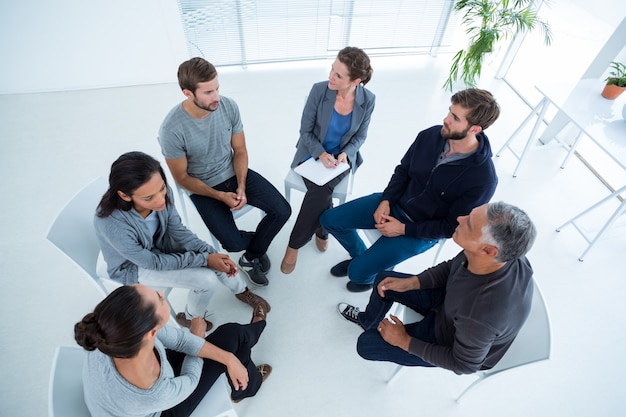 Group therapy in session sitting in a circle | Premium Photo