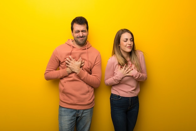 Premium Photo | Group of two people on yellow background having a pain ...