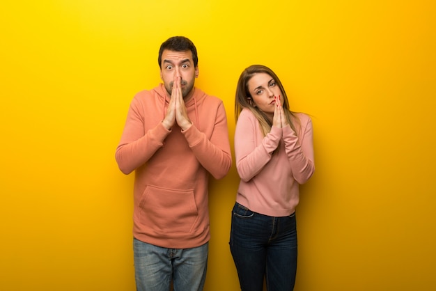 Premium Photo | Group of two people on yellow background keeps palm ...