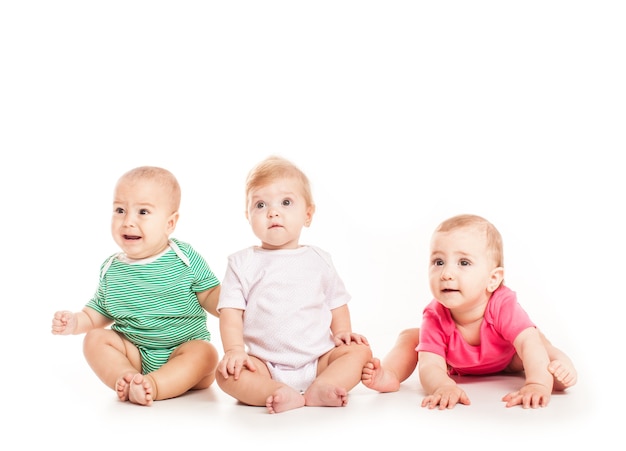 Premium Photo | Group of witty babies sitting in different clothes ...