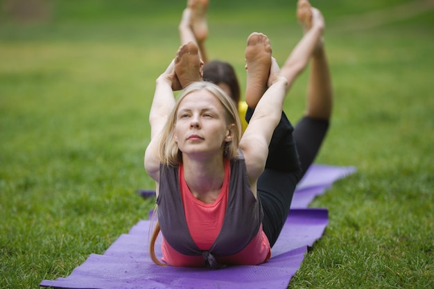 Premium Photo | A group of yogis in a graceful pose during outdoor ...