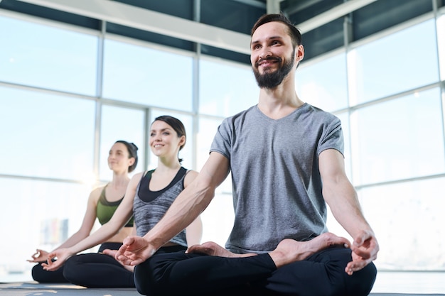 Premium Photo | Group of young happy active people looking at yoga ...