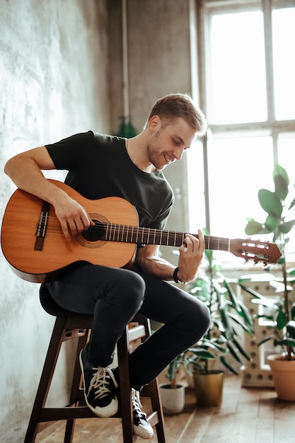 Free Photo | Guitarist man playing guitar at home