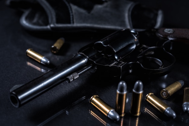 Premium Photo | Gun with on black background