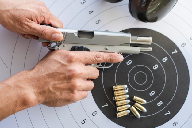 Premium Photo | Guns with ammunition on paper target