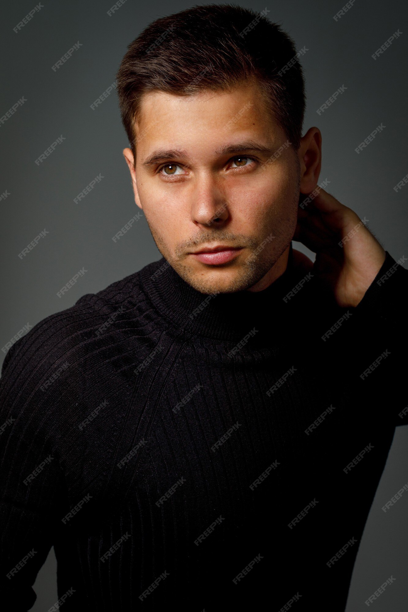 Premium Photo | Guy in a black turtleneck on a dark background