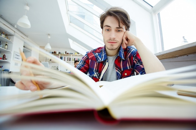 Guy reading under the influence of drugs.