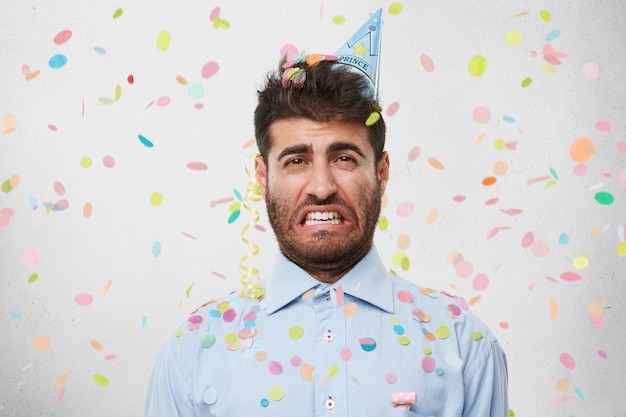 Free Photo | Guy with party hat and confetti