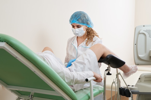 Premium Photo Gynaecologist Examining A Patient Sitting On Gynecological Chair