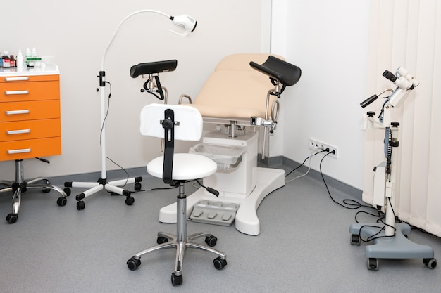 Premium Photo Gynecological Cabinet With Chair And Other Medical Equipment In Modern Clinic
