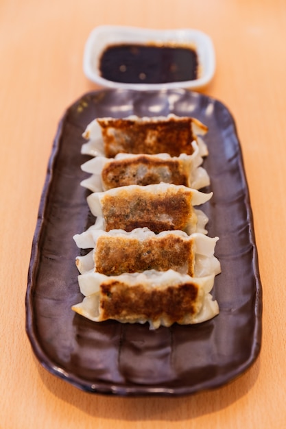 Premium Photo | Gyoza (japanese pan-fried dumplings) served with sauce ...